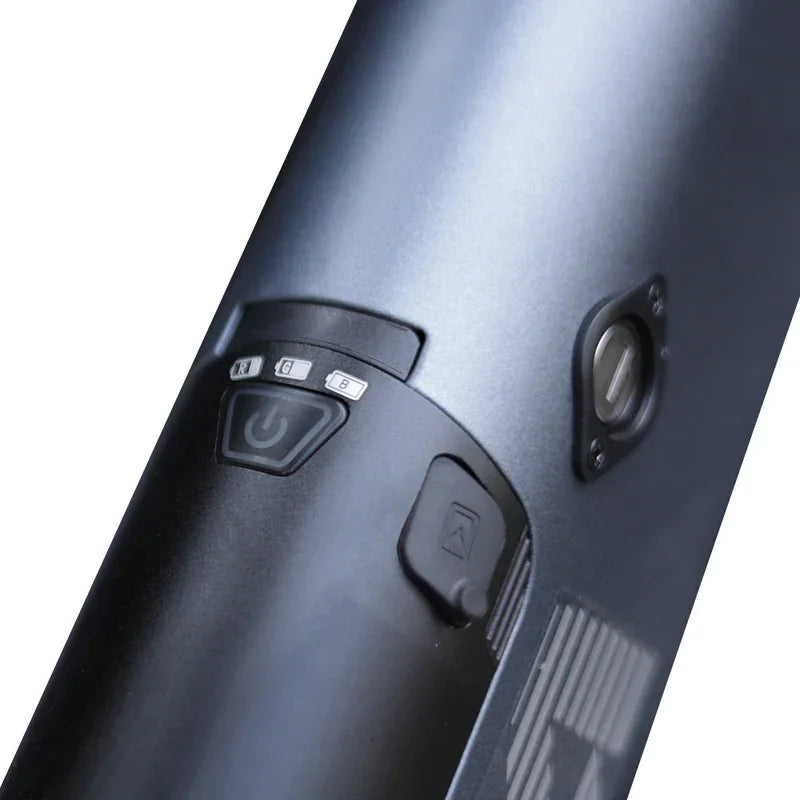Close-up of a black electronic device with control buttons on a white background