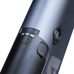Close-up of a black electronic device with control buttons on a white background
