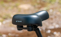 Close-up of a black bike seat with 'Engwe' branding against a blurred natural background. - Engwe EP-2 3.0 Boost Electric Bike