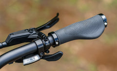 Close-up of Engwe EP-2 3.0 Boost Electric Bike handlebar grips with a blurred natural background