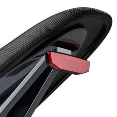Close-up of a black bicycle seat with a red reflector on a white background