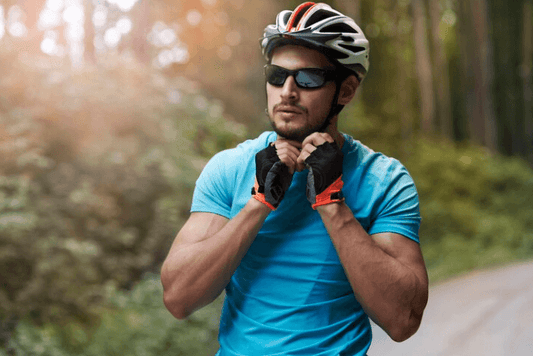 Man wearing a black and white cycling helmet and sunglasses preparing for e-bike ride outdoors