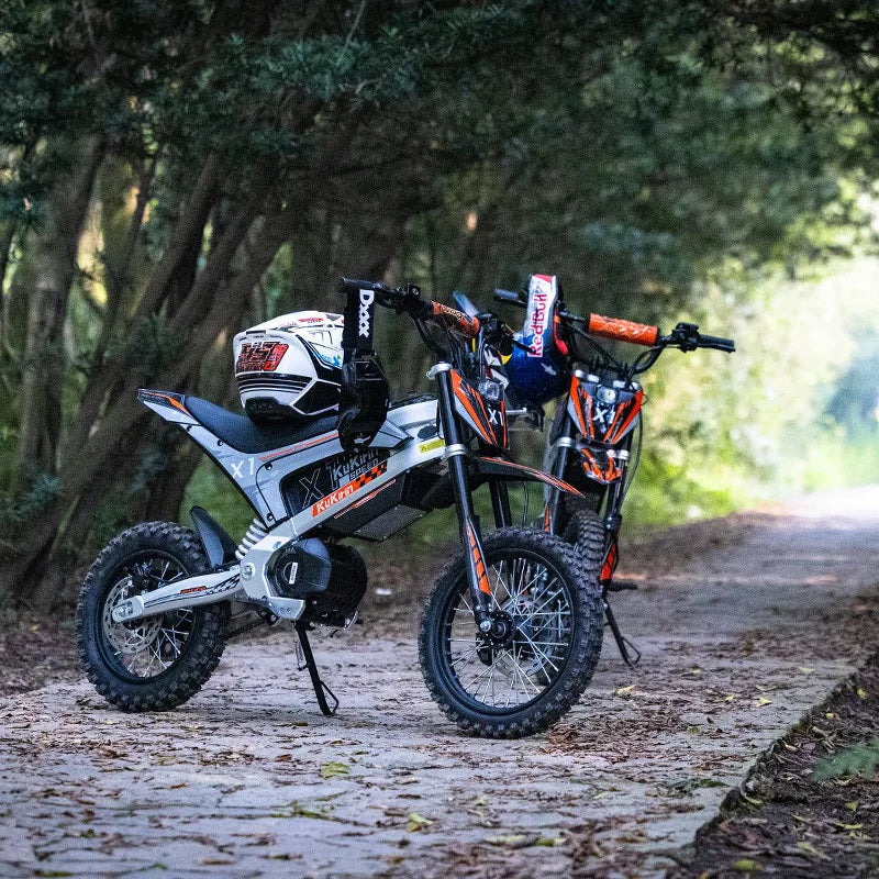 Two KuKirin X1 Electric Scooter Motorcycles on a forest path with trees in the background